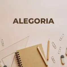 Alegoria: co to? Notatnik, ołówki, linijka i spinacze na jasnym tle.